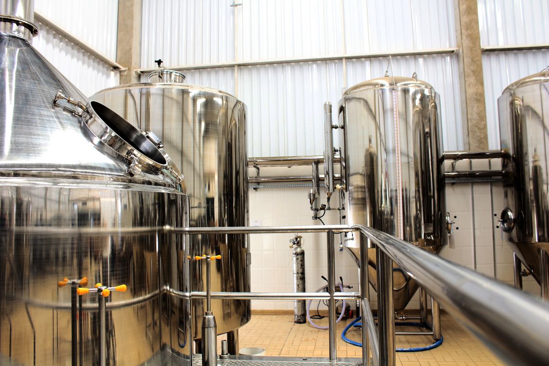 Stainless steel tanks and pipework in a brewery.